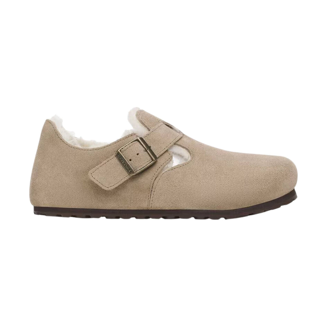 Beige suede clog-style shoe with shearling lining and a buckle strap