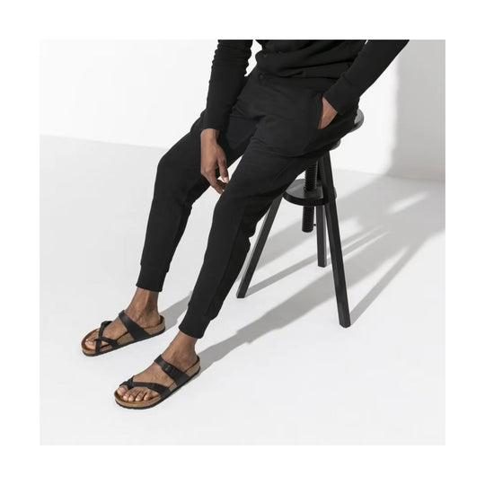 Black two-strap thong sandal with a cork footbed and toe loop