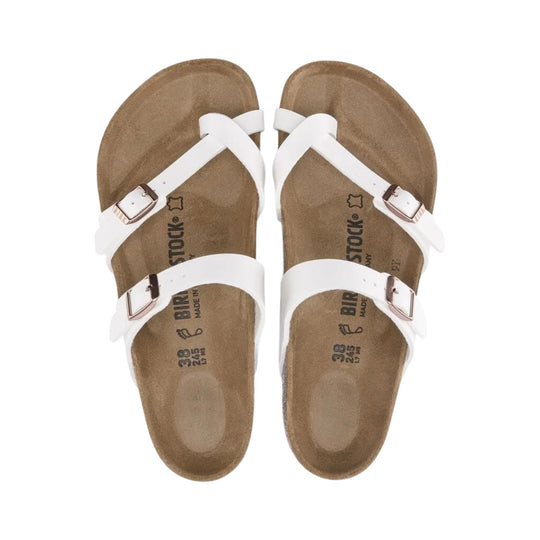 White strappy Birkenstock sandals with buckled straps and tan footbeds, top view