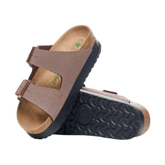 Brown two-strap cork footbed sandal with buckle details and black tread sole