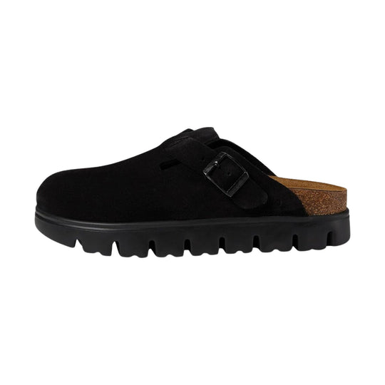 Black suede slip-on clog with a buckled strap and cork footbed, side view
