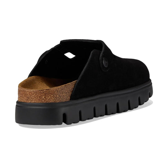 Black suede clog with an open back, cork footbed, and thick lug sole