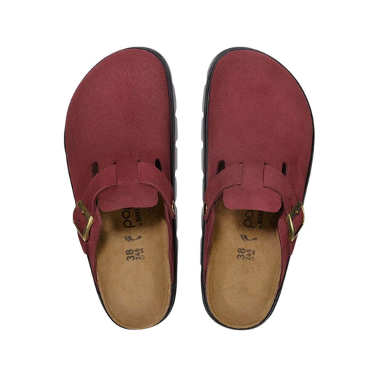Pair of burgundy clogs with buckle straps and tan footbeds, top view