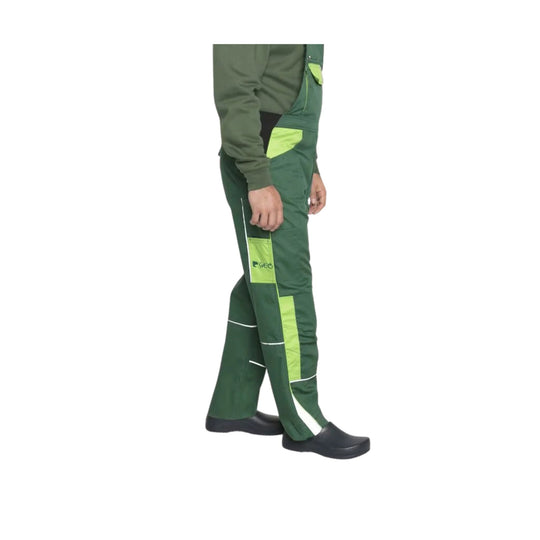 Green work pants with lime panels and reflective trim, shown with dark slip-on clogs