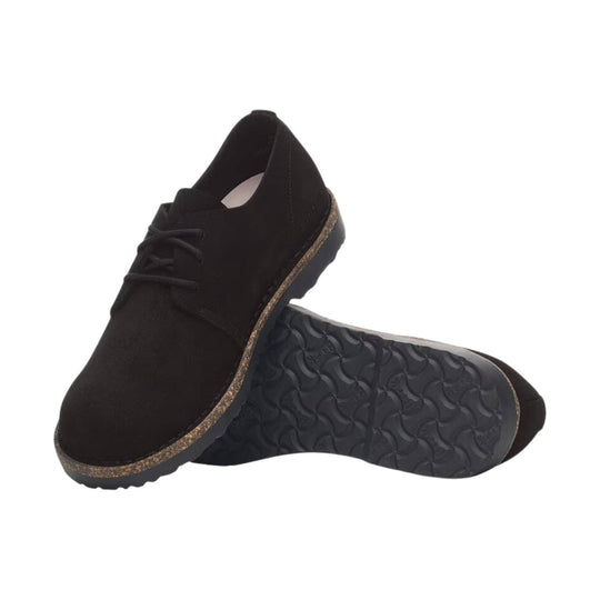 Black suede lace-up shoe with a thick textured sole, shown from the side and bottom