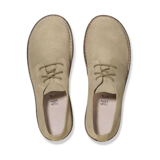 Pair of beige suede lace-up low-top shoes shown from above.