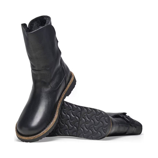 Black pull-on boot with shearling lining and thick treaded sole, shown in side and sole view