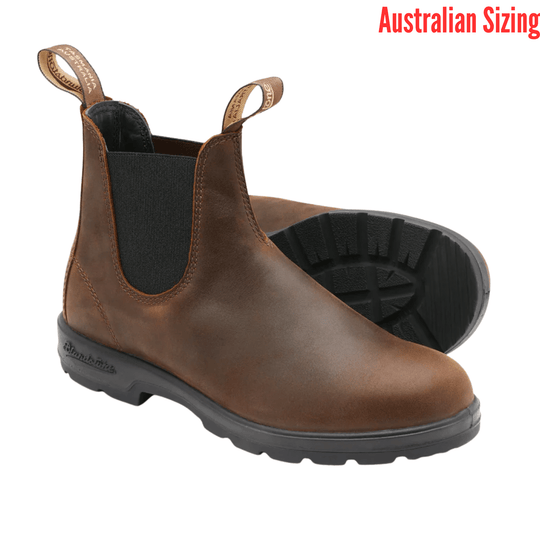 Brown Chelsea boots with black soles and pull tabs, shown as a pair on a white background
