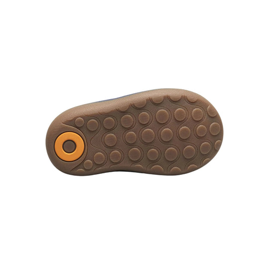 Brown boot sole with circular tread pattern and orange heel accent