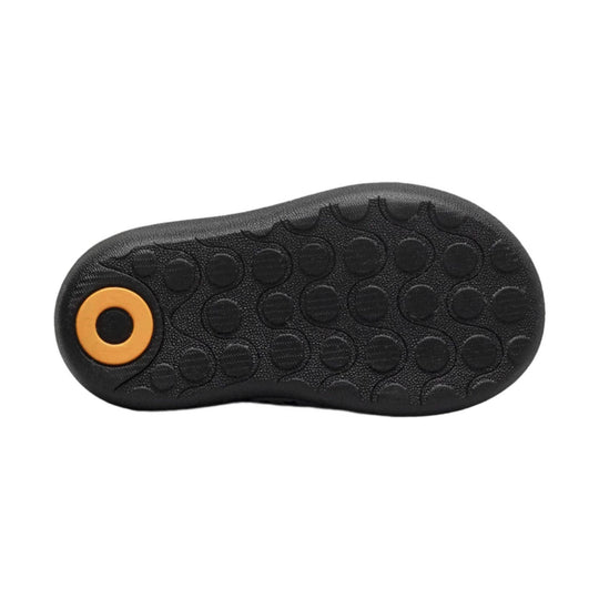Black textured boot sole with round orange heel insert