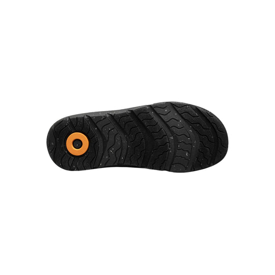 Black boot outsole with wavy tread and orange circular insert near the heel