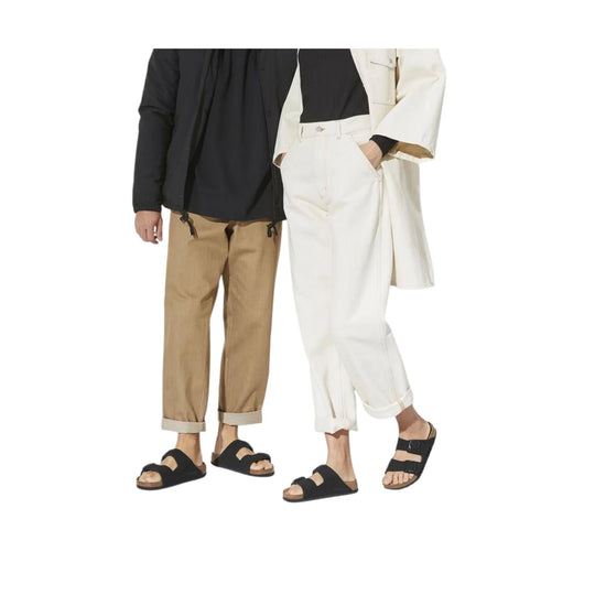 Black two-strap cork footbed sandals shown on two models with rolled pants