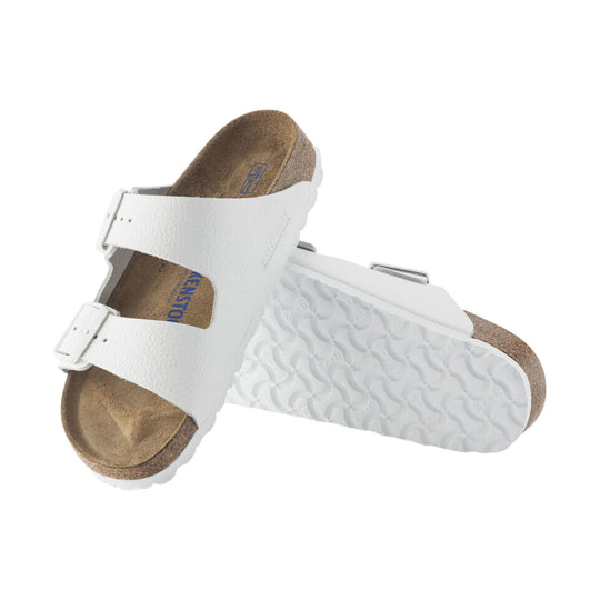 White two-strap sandal with buckles and cork footbed, shown from the side and top