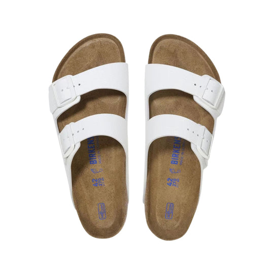 White double-strap slide sandals with brown cork footbeds, seen from above