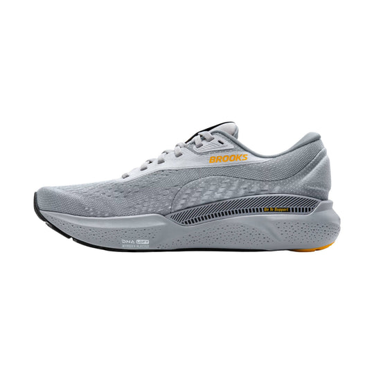 Gray running shoe with orange side logo and black support panel on the sole