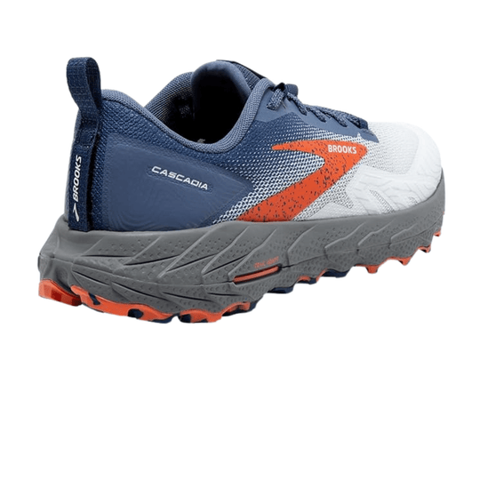 Blue, white, and orange trail running shoe with rugged gray outsole and pull tab