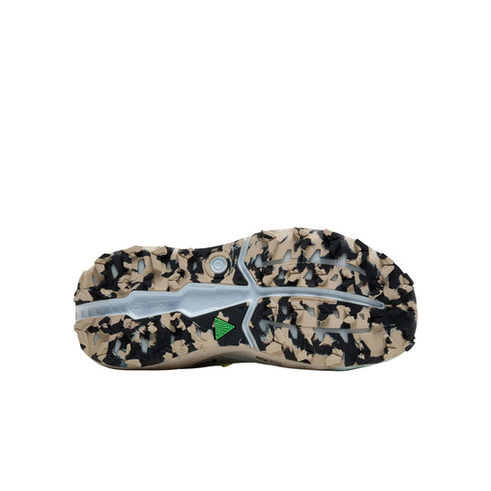 Trail shoe outsole with beige and black lugs, translucent midfoot shank, and Brooks branding