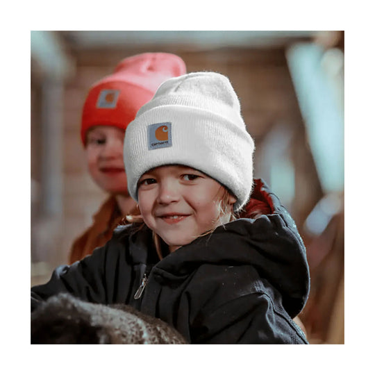 White knit beanie with a Carhartt logo patch, worn by a child