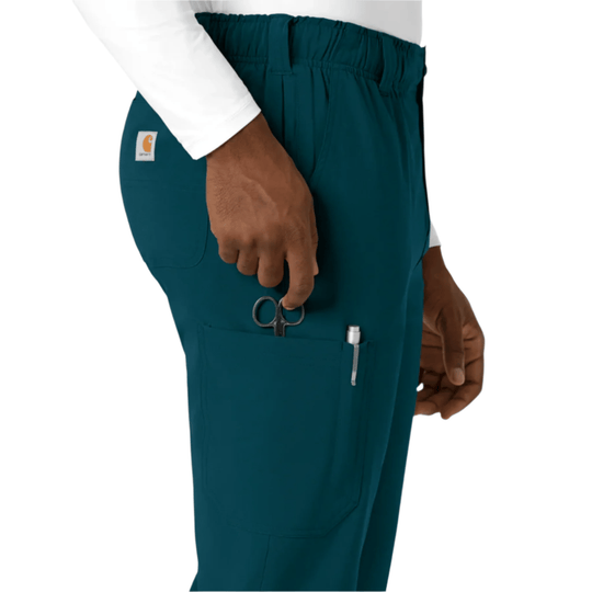 Teal straight-leg scrub pants with cargo pocket, pen slot, and scissors clipped at the waist