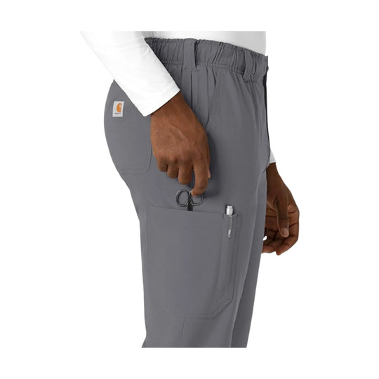 Gray scrub pants with side cargo pocket, pen slot, and utility scissors tucked in the pocket