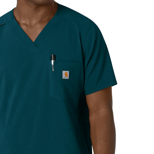 Teal V-neck scrub top with chest pocket, pen slot, and small logo patch