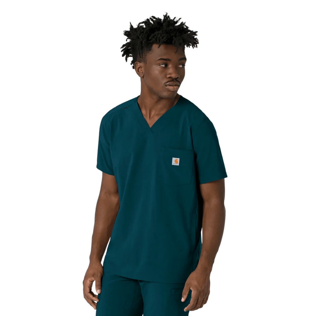 Teal V-neck scrub top with a chest pocket and small logo patch, worn with matching pants