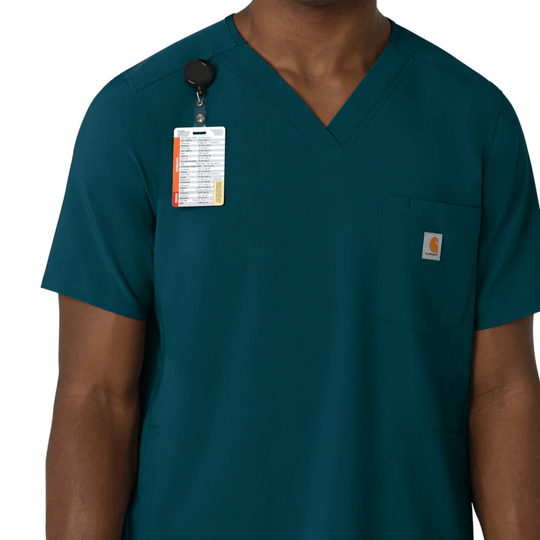 Teal V-neck scrub top with chest pocket and clipped ID badge