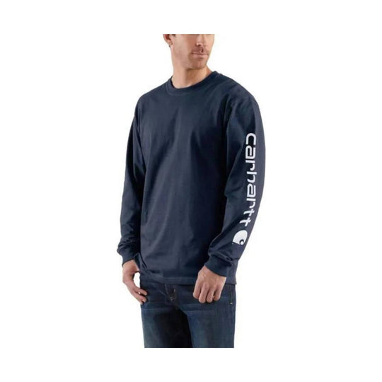 Man wearing a navy long-sleeve shirt with a Carhartt logo on a white background