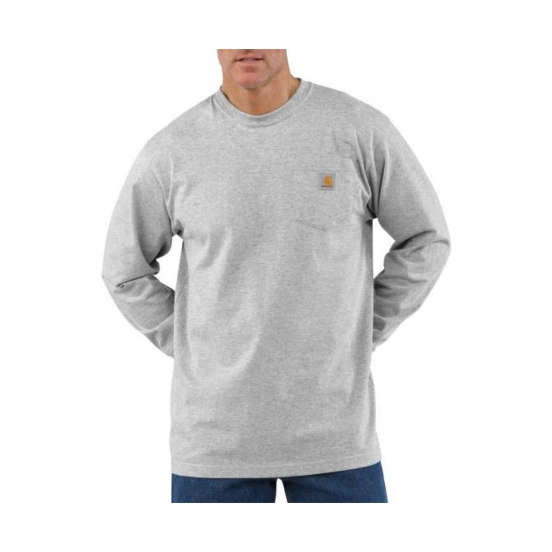 Person wearing a gray long-sleeve shirt with a brand logo on a white background