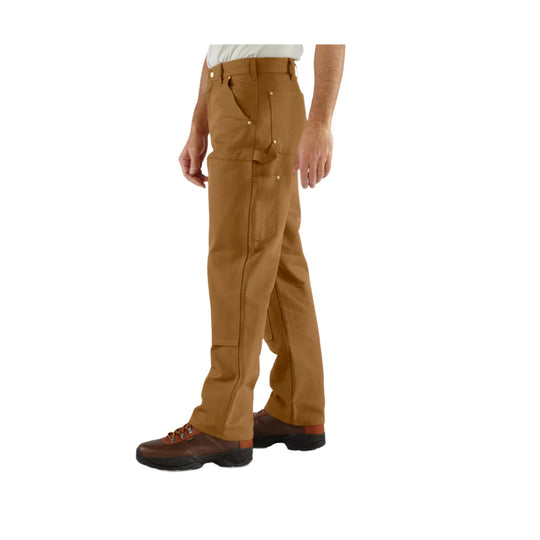 Brown work pants with double front panels and multiple utility pockets, shown on a model with work boots