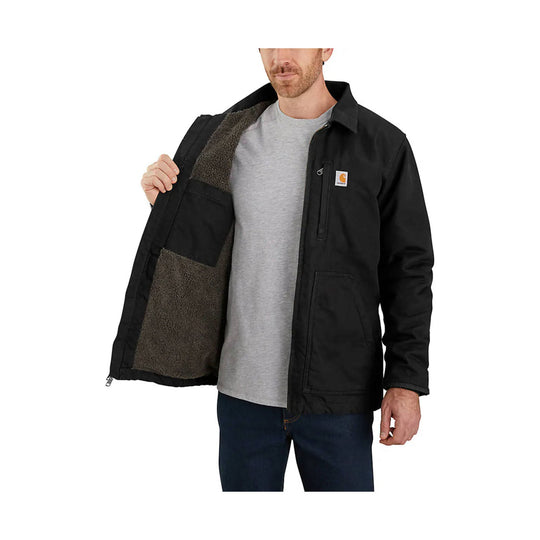 Black insulated jacket with sherpa lining, chest logo patch, and multiple front pockets, worn open over a gray T-shirt