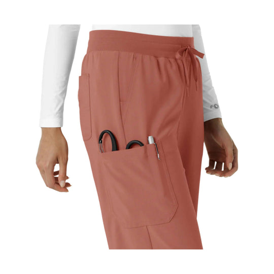 Rust-colored scrub pants with drawstring waist, large cargo pocket, and tool pocket