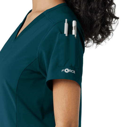 Teal V-neck scrub top with chest pocket, pen slot, and FORCE logo on the sleeve