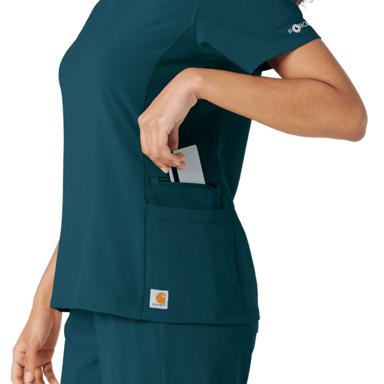 Teal short-sleeve scrub top with side pockets and a pen slot, shown in side view