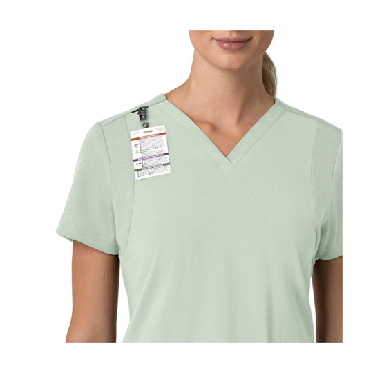 Light mint green V-neck scrub top with short sleeves and a clipped product tag on the left chest.