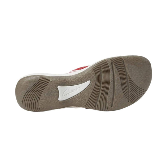 Brown rubber outsole with wavy tread and a white Clarks insert