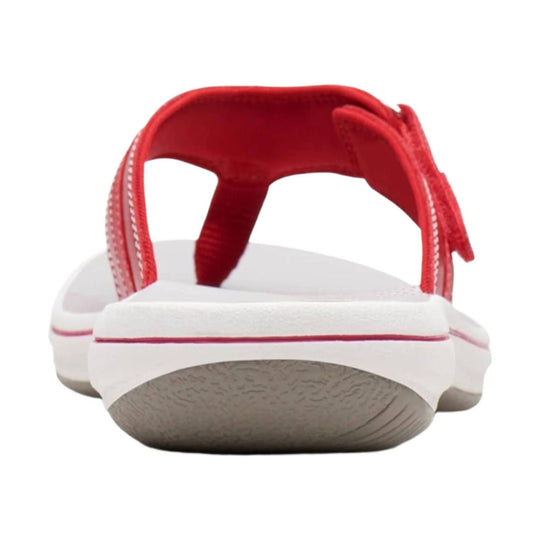 White slip-on sandal with a red back strap and white/red outsole, shown from the rear