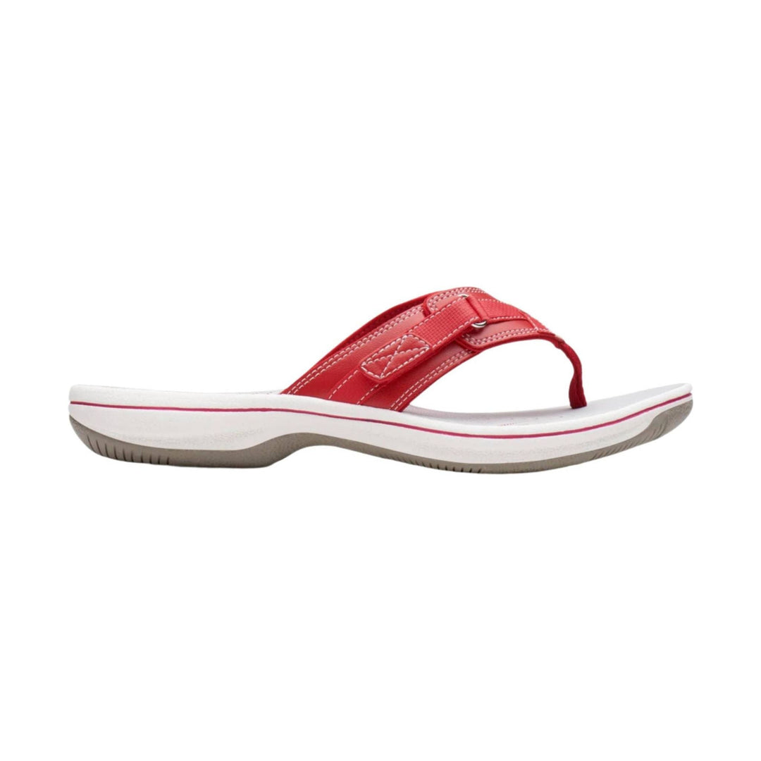 Red thong sandal with a white platform sole and stitched strap detail