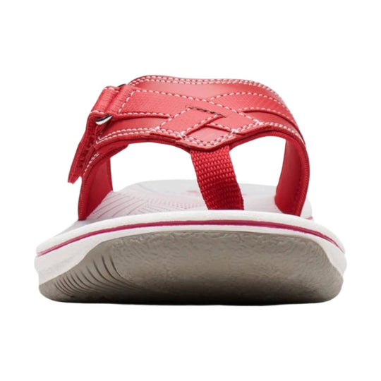 Red thong sandal with stitched straps, toe post, and white sole