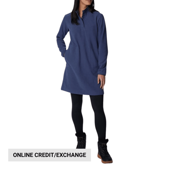 Woman wearing a blue long-sleeve fleece dress with a short stand collar, black leggings, and black boots; text reads ONLINE CREDIT/EXCHANGE