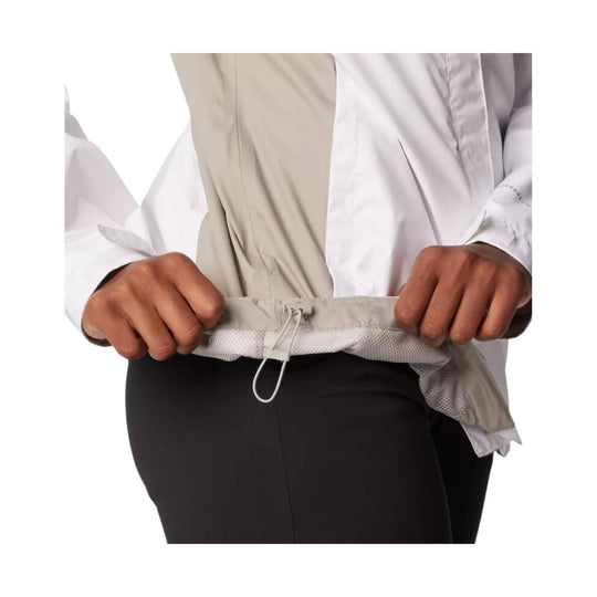 Lightweight white and beige hooded jacket being cinched at the hem
