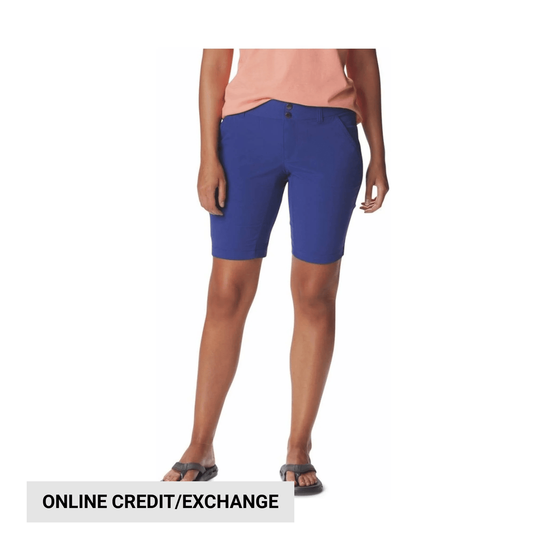 Royal blue women’s knee-length hiking shorts on a model, with front button closure and side pockets