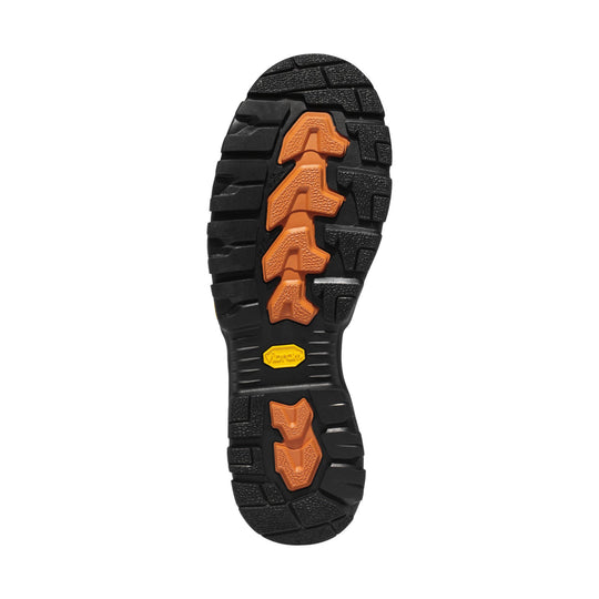 Black lugged boot outsole with orange traction inserts and yellow Vibram logo