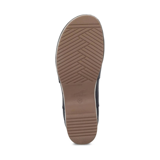 Brown boot sole with herringbone tread and embossed Dansko logo