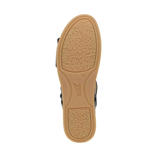 Tan shoe outsole with textured tread pads and Dansko logo