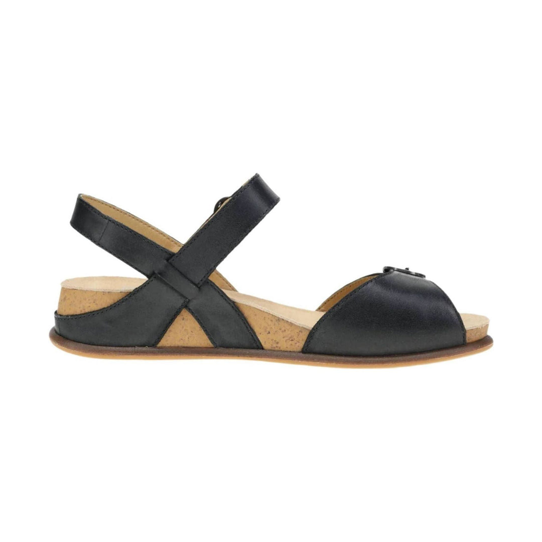 Black leather sandal with crossed ankle straps, cork side panels, and a low flat sole