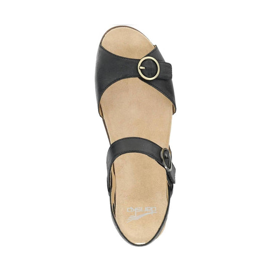 Black two-strap sandal with gold buckles and tan footbed, top view