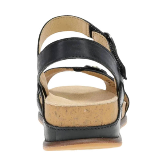 Black leather sandal with wide ankle straps and a cork wedge heel, rear view