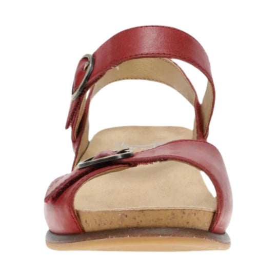 Red leather sandal with two wide straps and buckle details, shown from the front