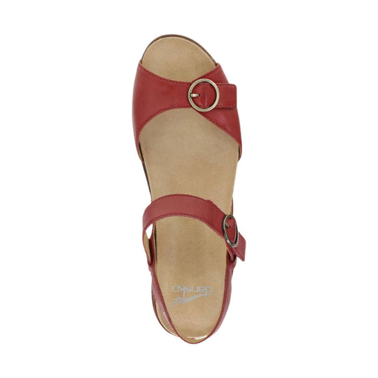 Red leather sandal with two buckle straps and tan footbed, viewed from above